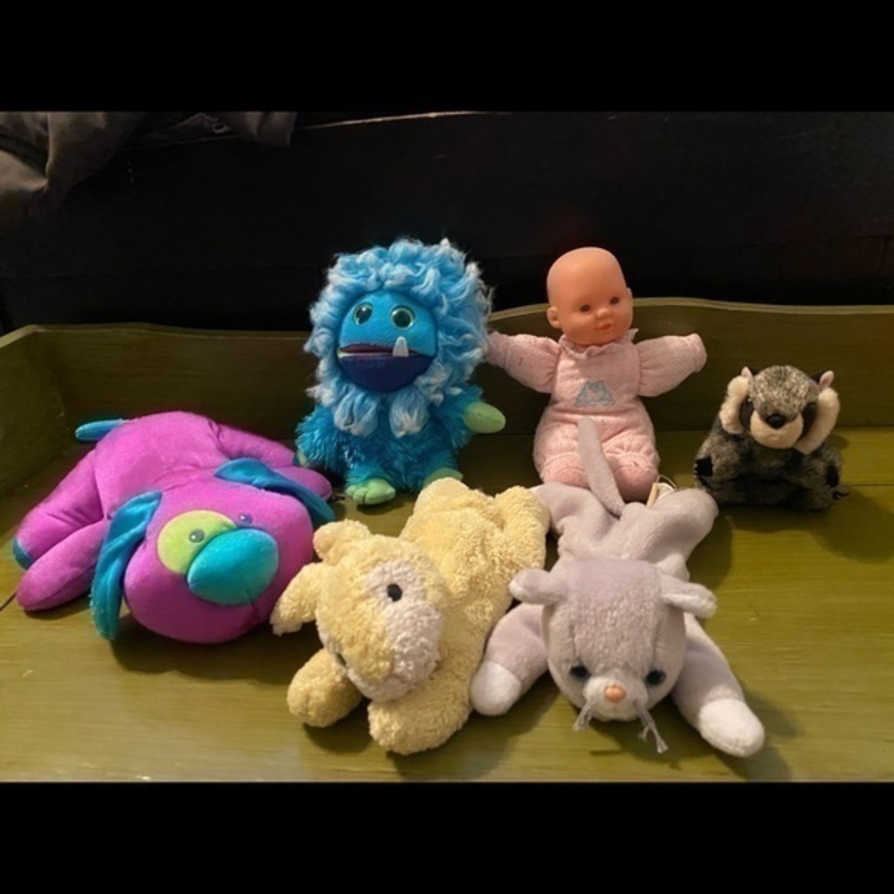 Stuffed animals and a little baby doll